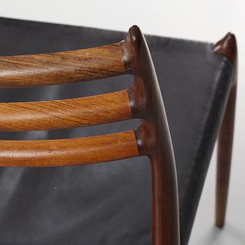 Niles Otto Møller, a rosewood veneered table with four chairs, JL Møller, Denmark, 1950's/60's.