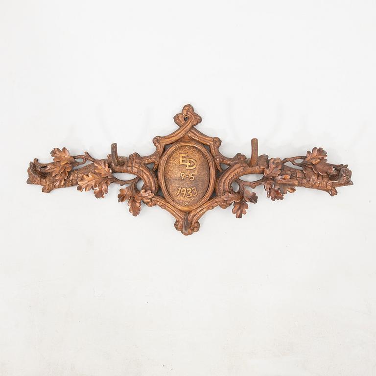 Wall-mounted coat rack dated 1933.