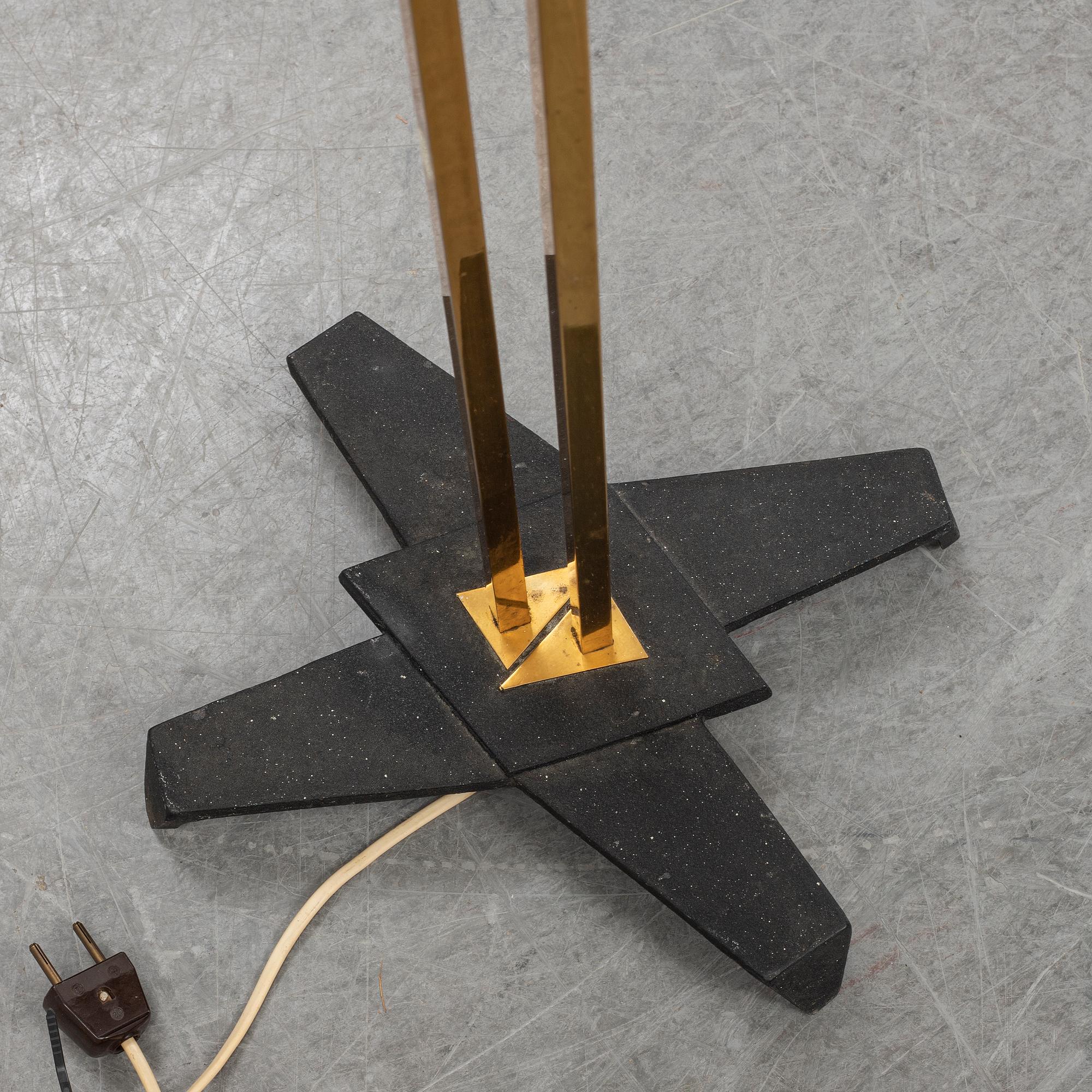 A 1950s brass and glass floor lamp.