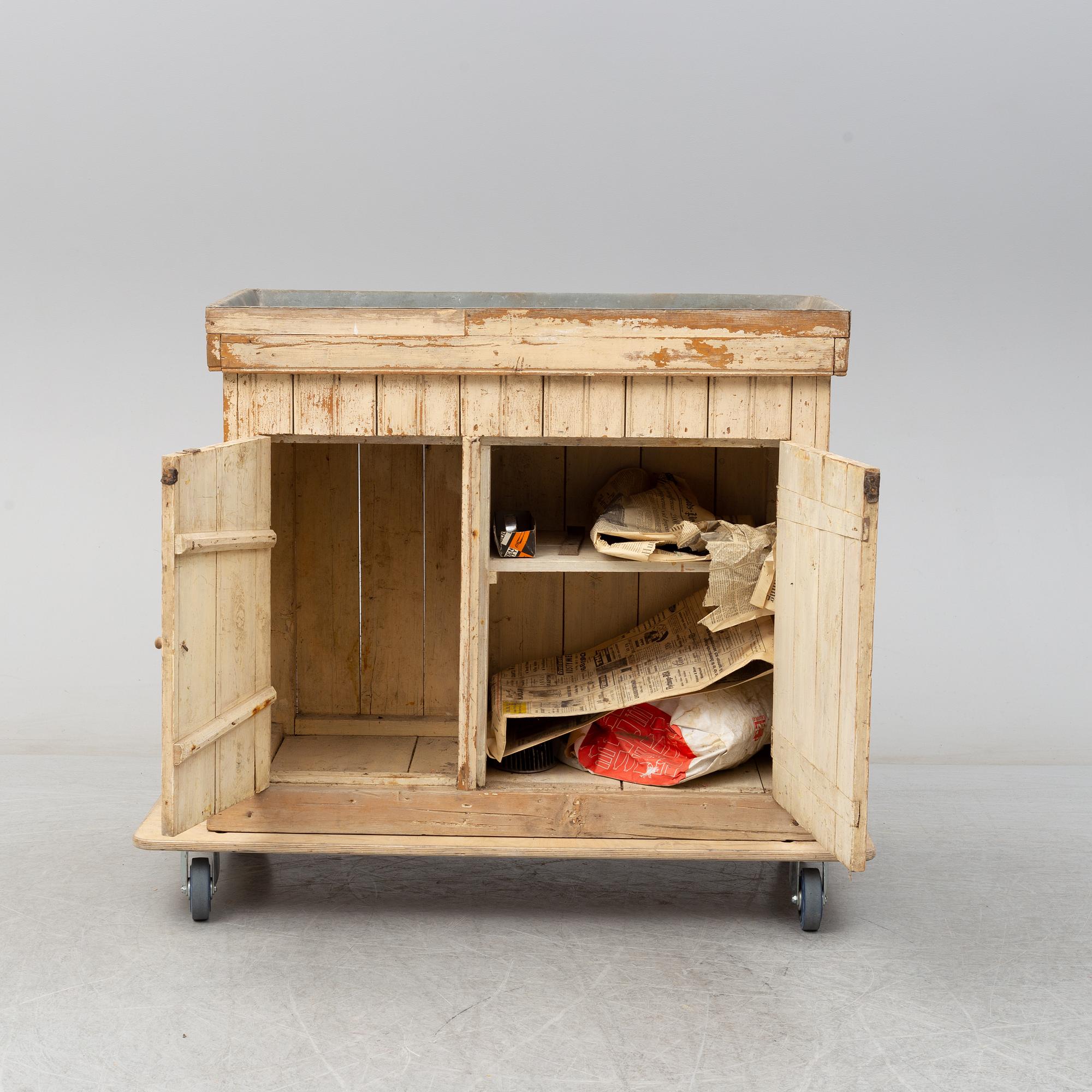 A late 19th Century cabinet with zink top.