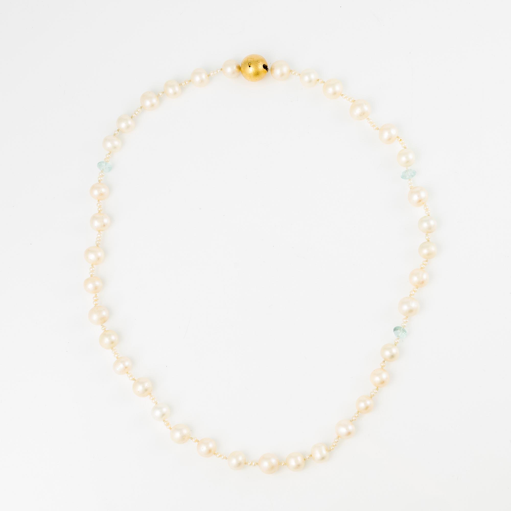 Ole Lynggaard clasp in 18K gold with a necklace of cultured freshwater pearls.