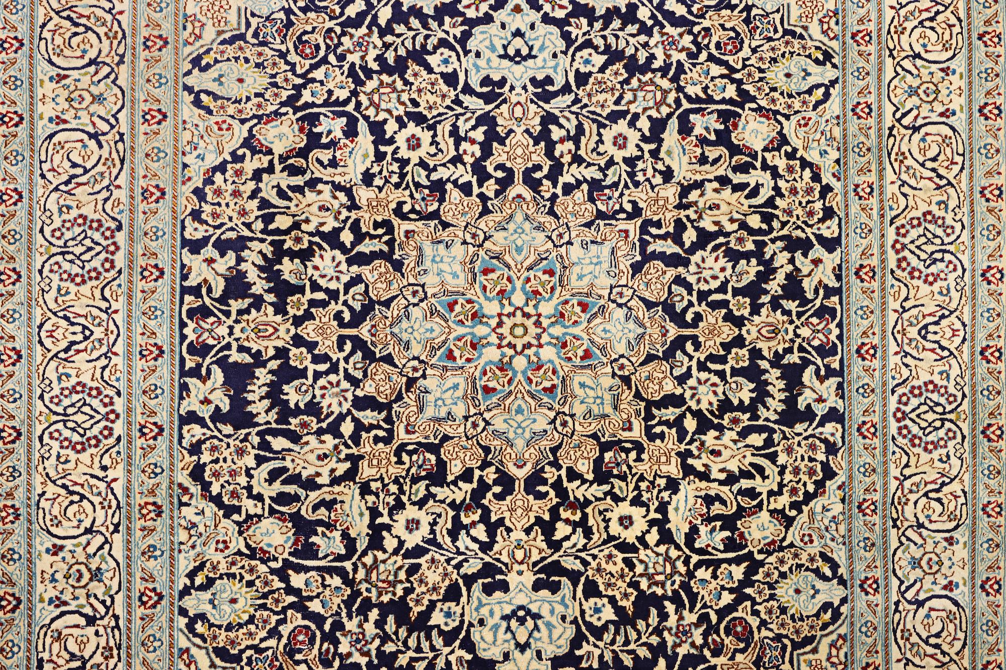 A Nain carpet, part silk, c. 338 x 244 cm.