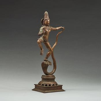 A bronze scupture of Krishna who has konkured the five headed serpant, India, early 20th Century.