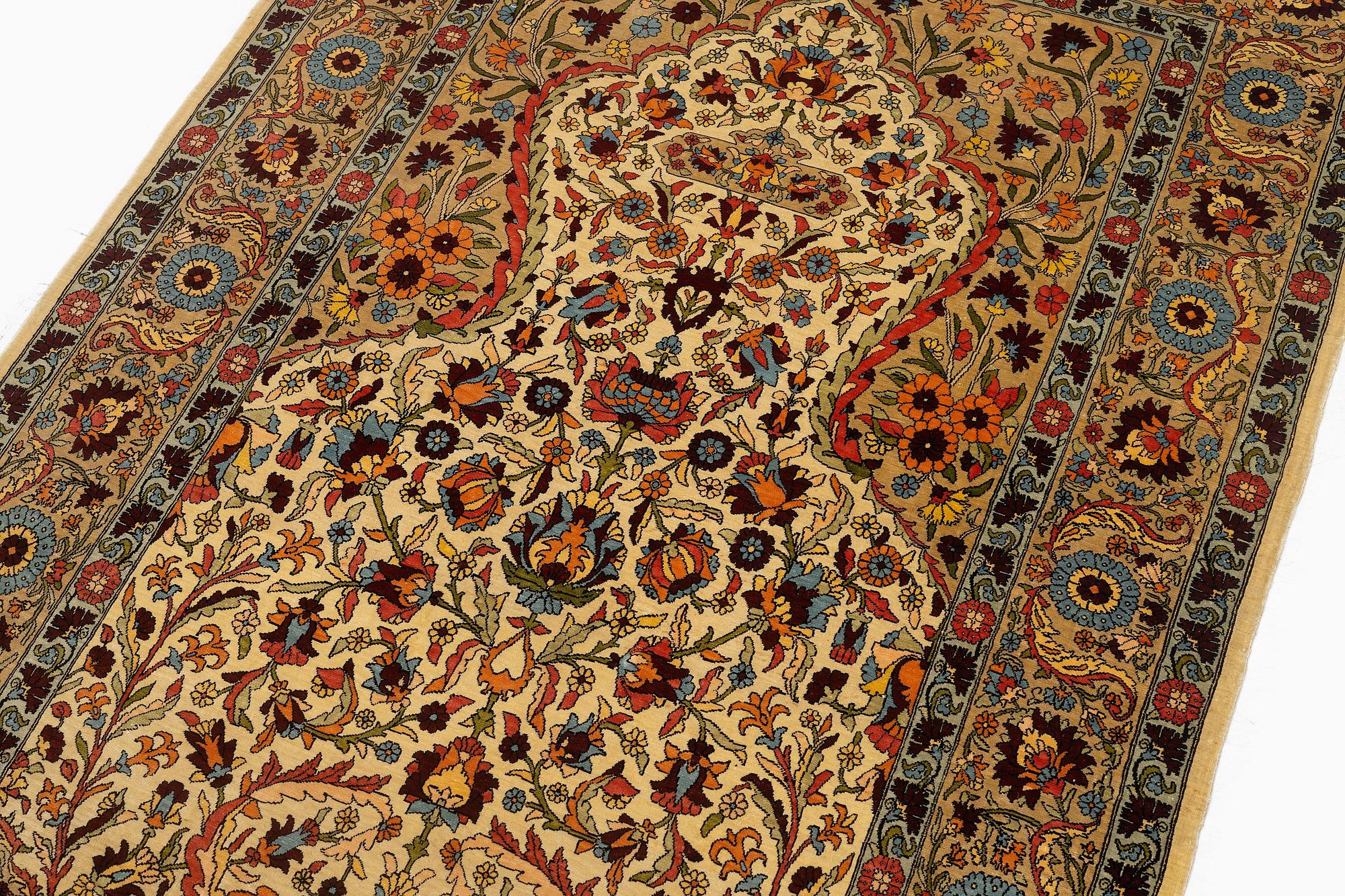 A semi-antique silk Hereke rug, c. 155 x 103 cm.
