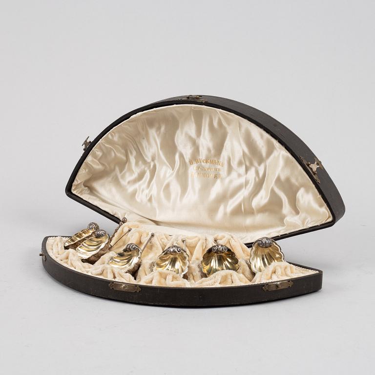 A set of six German parcel-gilt silver 800 salt cellars in fitted case.