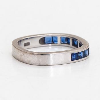 An 18K white gold eternity ring, with square-cut sapphires, Switzerland.