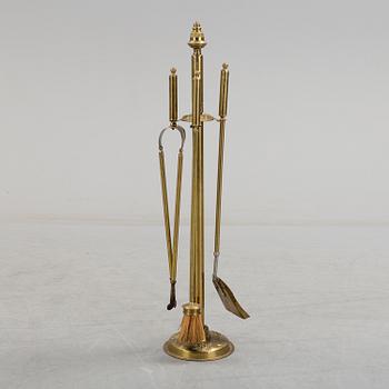 A set of 4 brass fire utensils with stand, 20th Century.