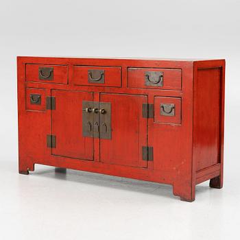 A Chinese red lacquered cabinet, 20th century.