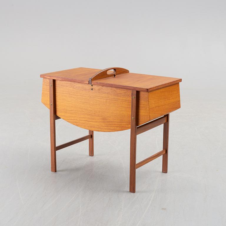 A mid 20th century teak sewing table.