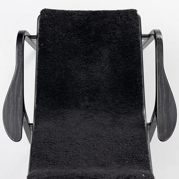 Yngve Ekström, a 'Lamino' easy chair with foot stool, Swedese 2010.
