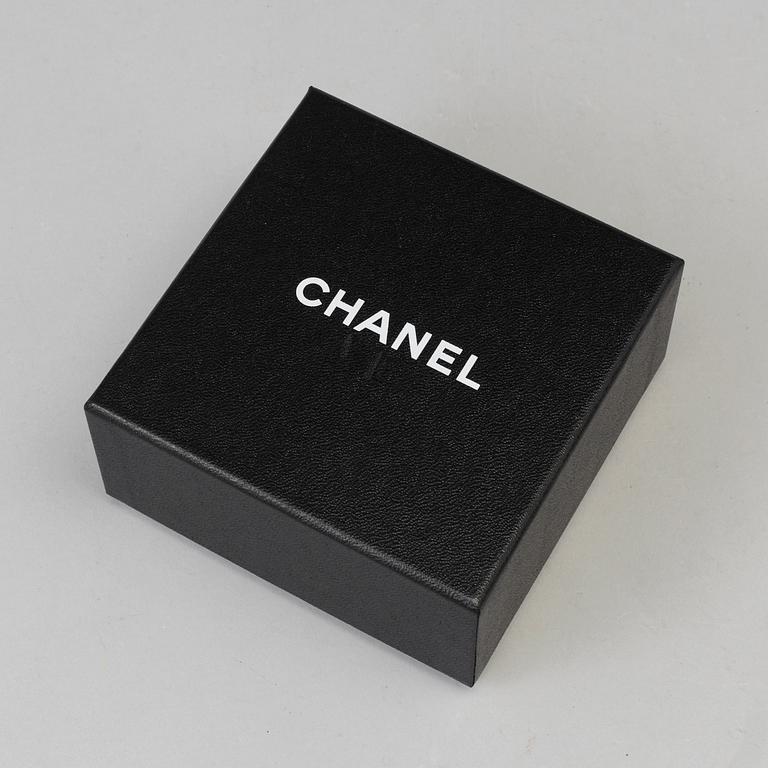 A Brooch by CHANEL.