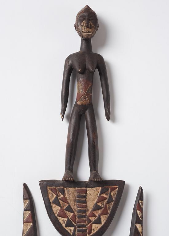 A sculptue and two masks reportedly from The Ivory coast, from the second half of the 20:th century.