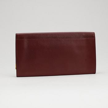 CARTIER, a red leather clutch or travel wallet.