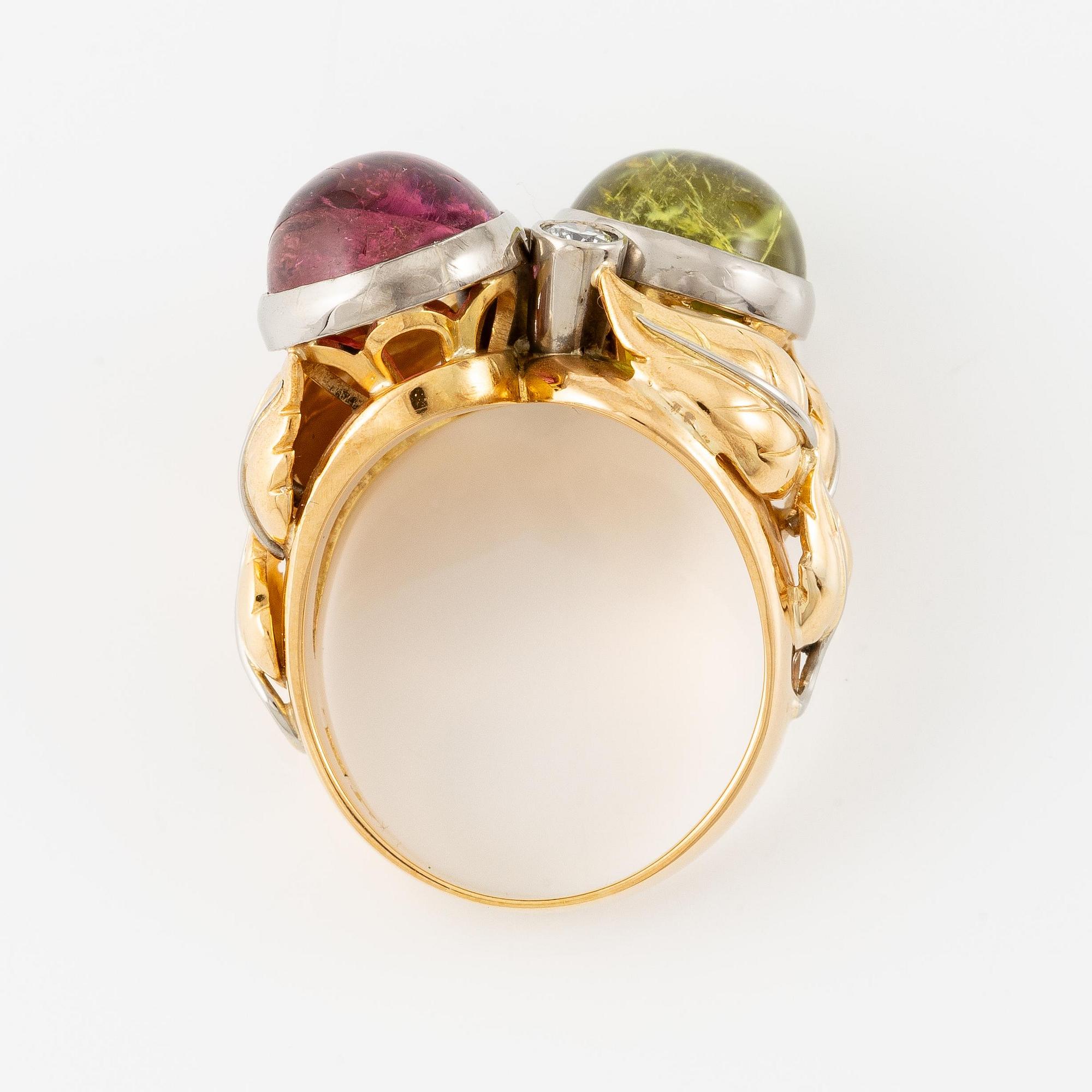 An 18K gold ring with cabochon-cut tourmalines.