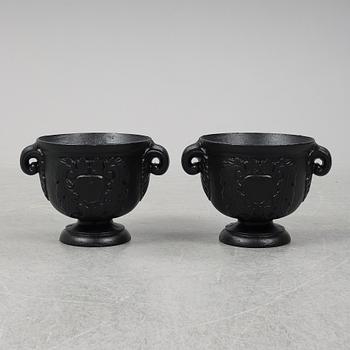 An early 20th Century pair of cast iron pots.