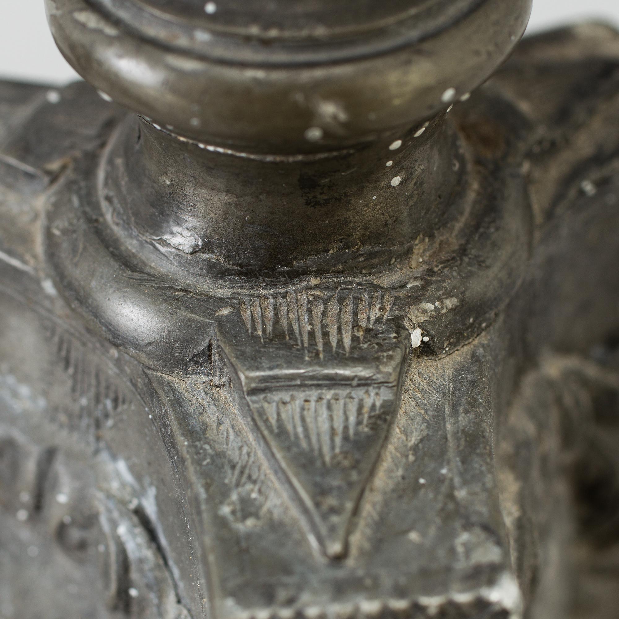 A pair of baroque pewter candlesticks, engraved date 1699.