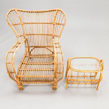 A 1950s rattan easy chair with ottoman and a magazine stand, Urjalan Koritehdas, Finland.