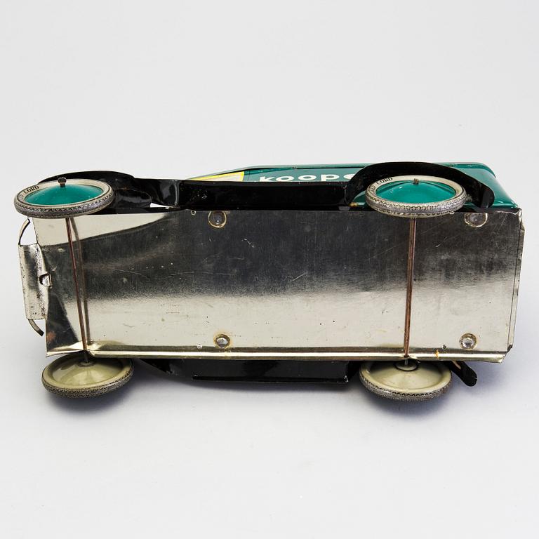 A tinplate biscuit jar in the shape of a truck 1930s.