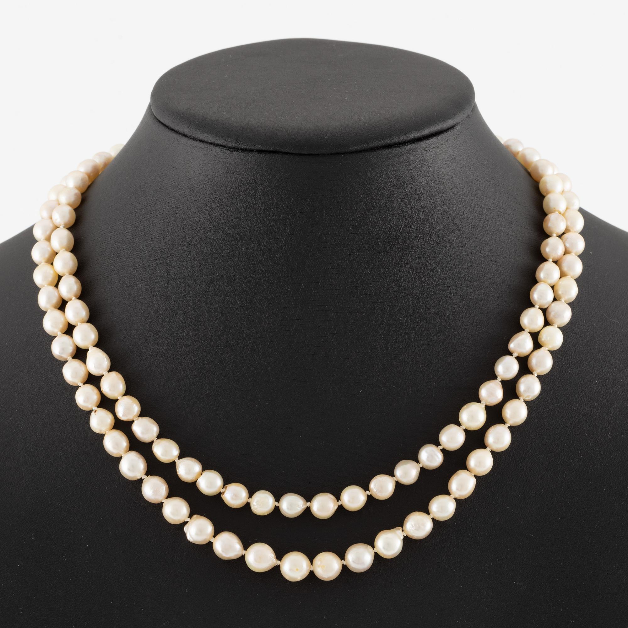 Pearl necklace, double-stranded with cultured pearls, with a clasp of silver set with pastes.