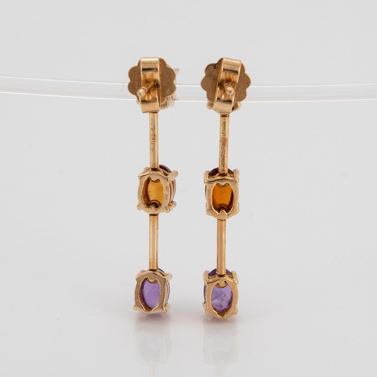 A pair of 18K gold earrings set with cabochon-cut citrines and amethysts.