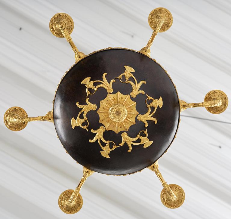 A patinated and ormolu six-light Empire chandelier, Stockholm, first part 19th century.