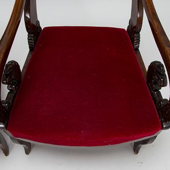 A pair of Russian/Baltic carved mahogany Empire armchairs, first half of the 19th Century.