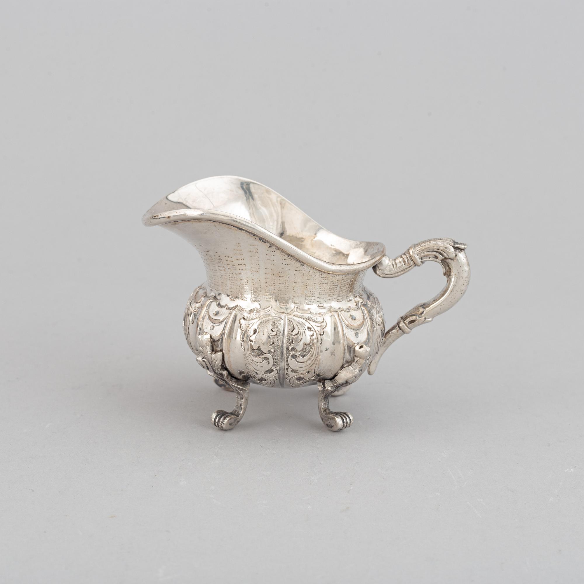 A silver teapot, creamer and sugar bowl, swedish import mark.