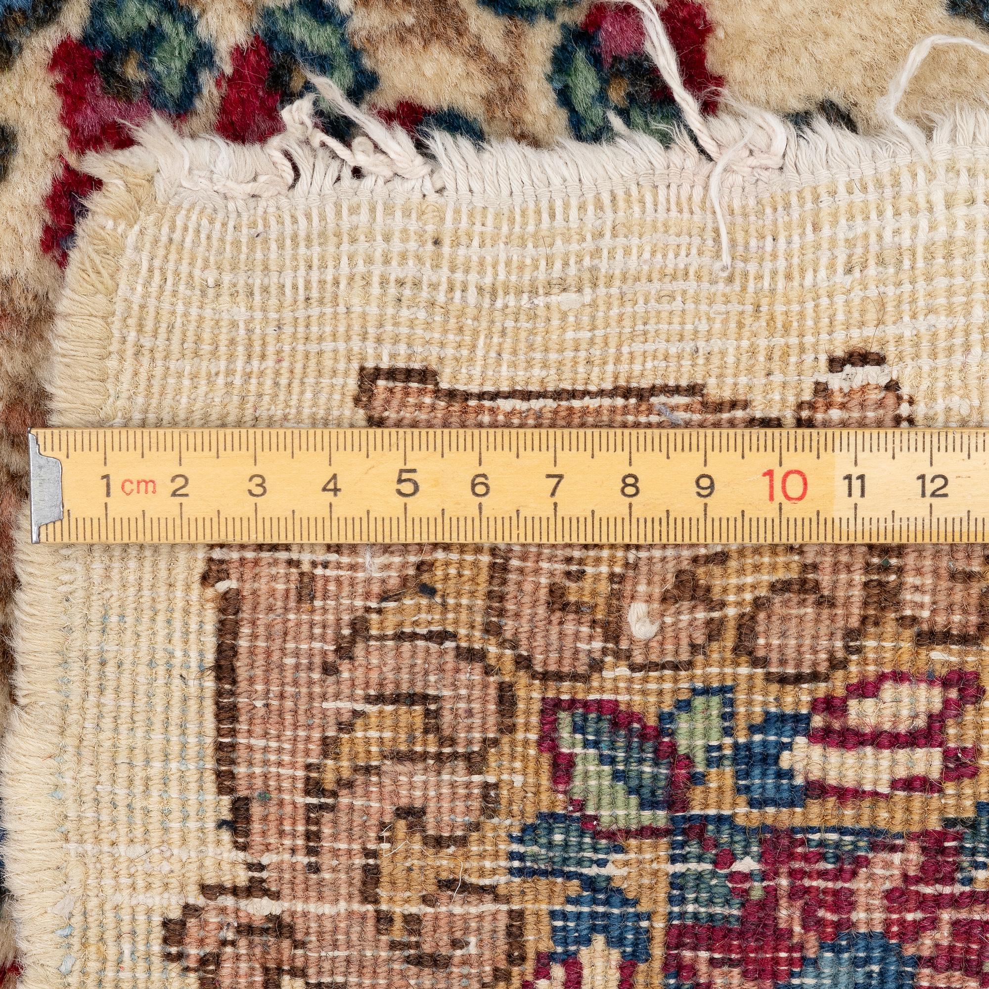 A pair of similar Kirman rugs, south Persia, c. 147 x 94 and 154 x 96 cm.