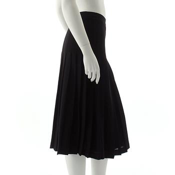 CÉLINE, a black pleated wool skirt.