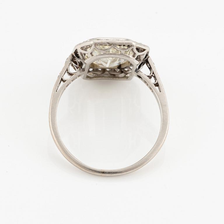 A platinum ring set with an emerald-cut diamond.