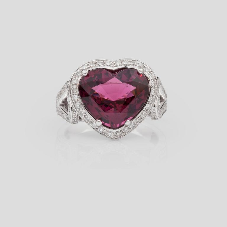 A 6.12 ct heart-shaped rhodolite garnet and brilliant-cut diamond ring. Total carat weight of diamonds circa 0.98 ct.