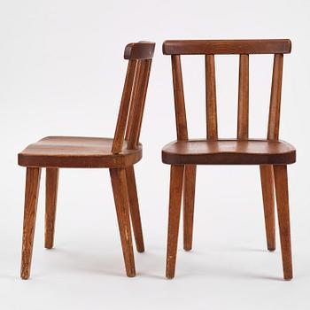 Axel Einar Hjorth, a set of six stained pine "Utö" chairs, Nordiska Kompaniet, Sweden, 1930s.