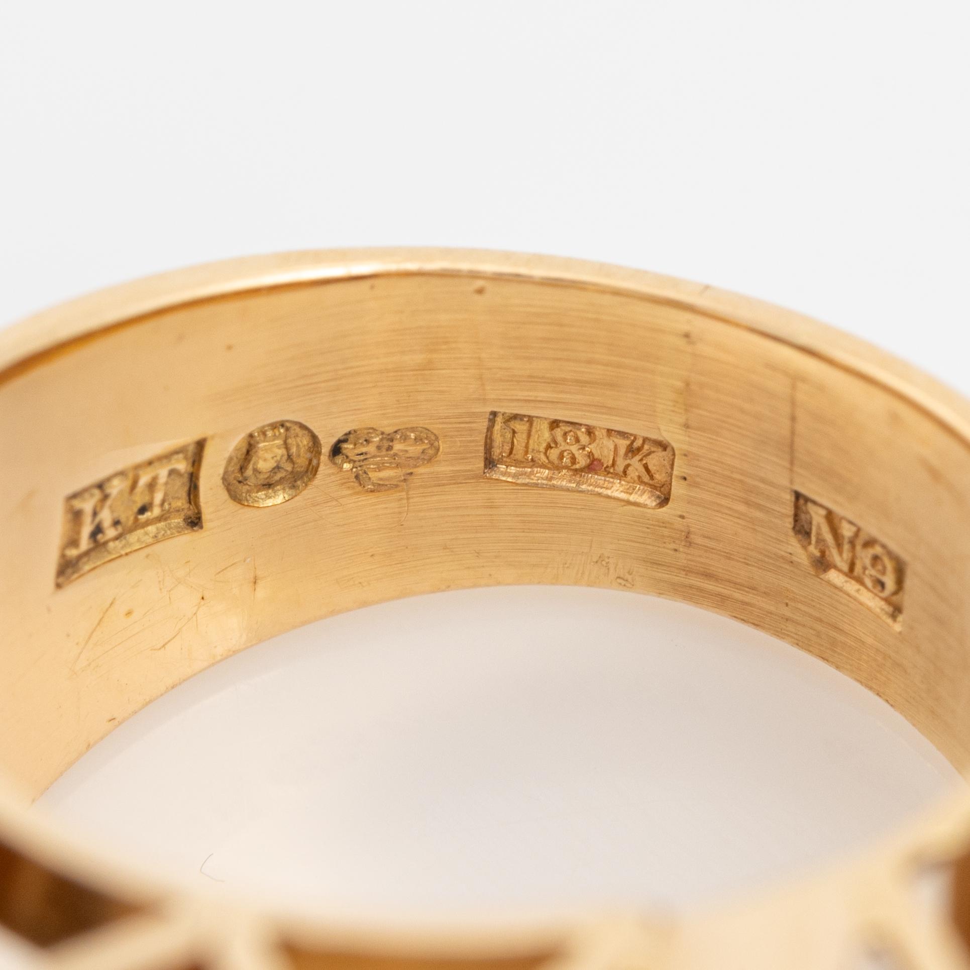 An 18K gold ring set with faceted quartz and old-cut diamons.