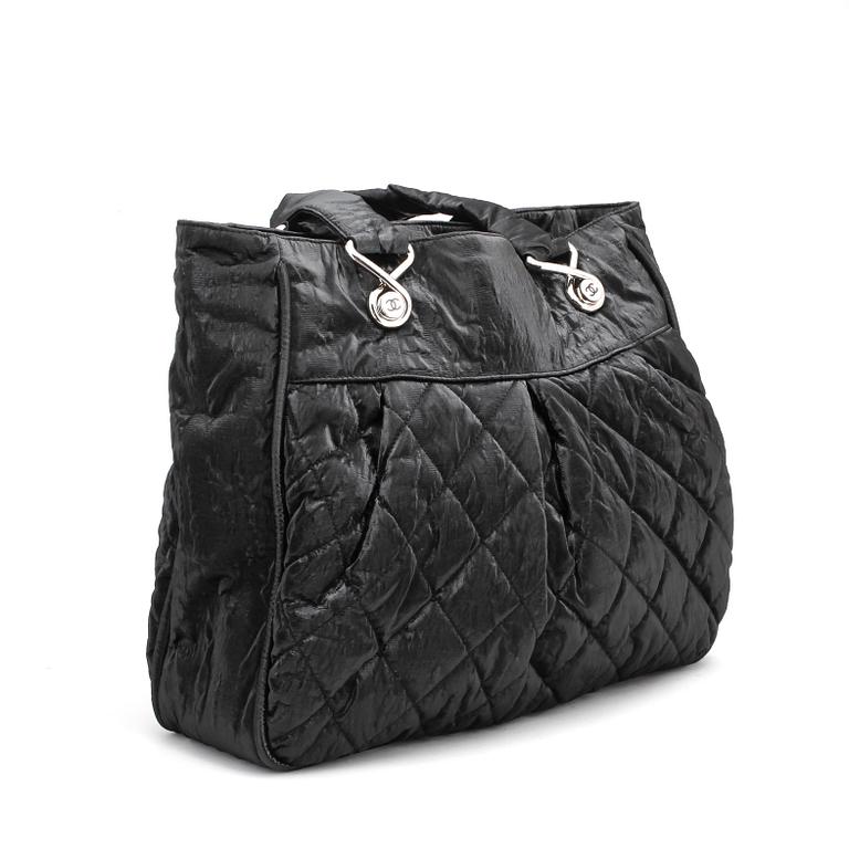 CHANEL a coated black quilted leather bag.