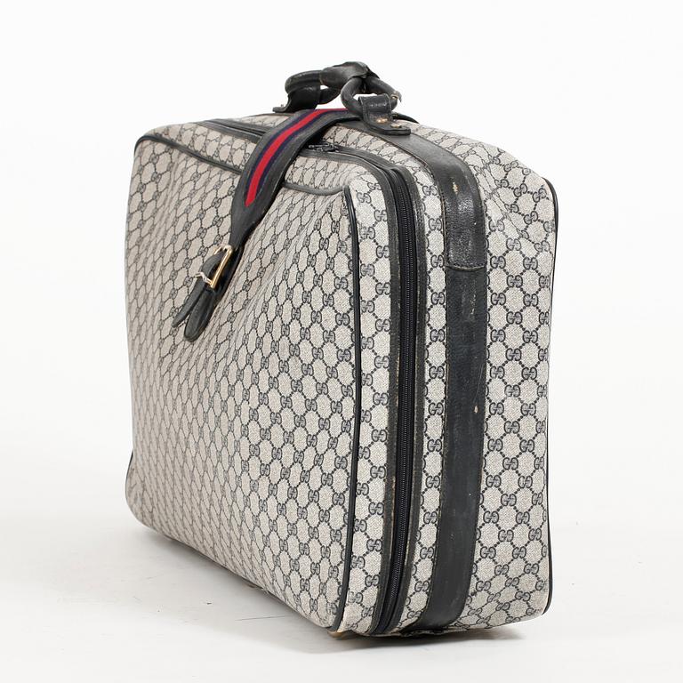 GUCCI, a blue monogram canvas suitcase.