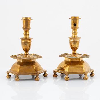 A pair of brass barock style candlesticks.