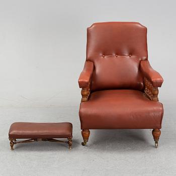 A late empire armchair with stool, mid 19th century.