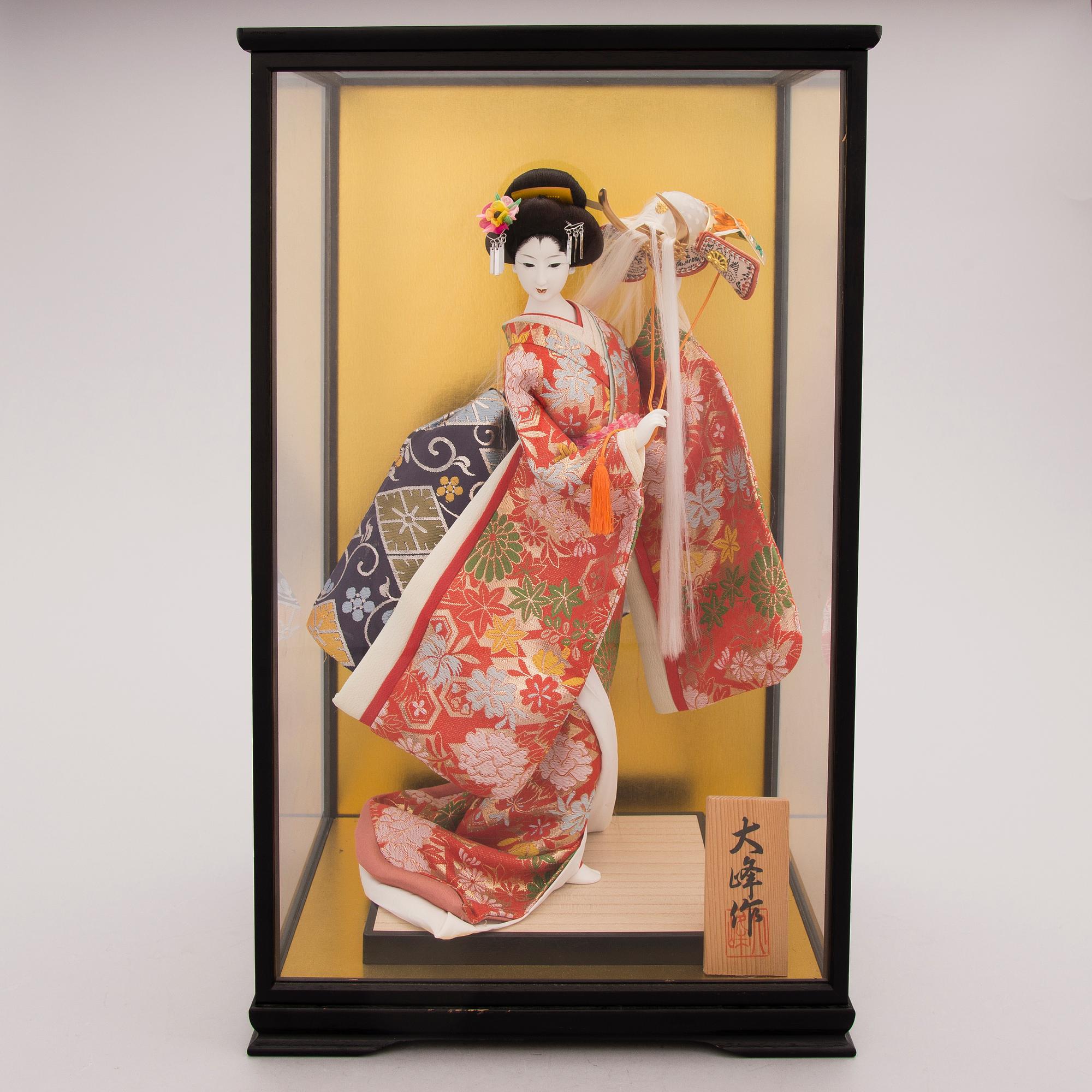 A latter half of the 20th century Japanese doll in showcase.