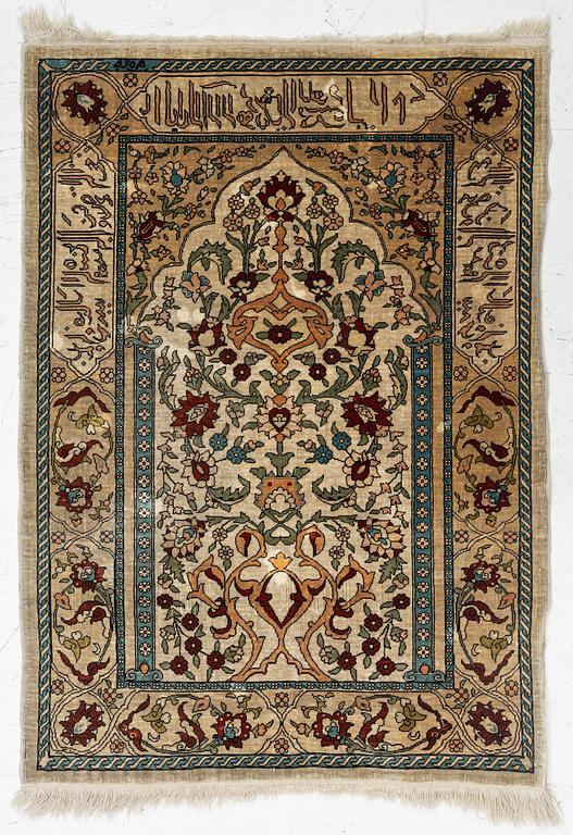 A Hereke silk rug, c. 73 x 52 cm.