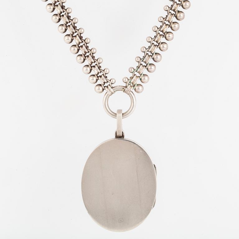 A LOCKET with partly silver and enamel.