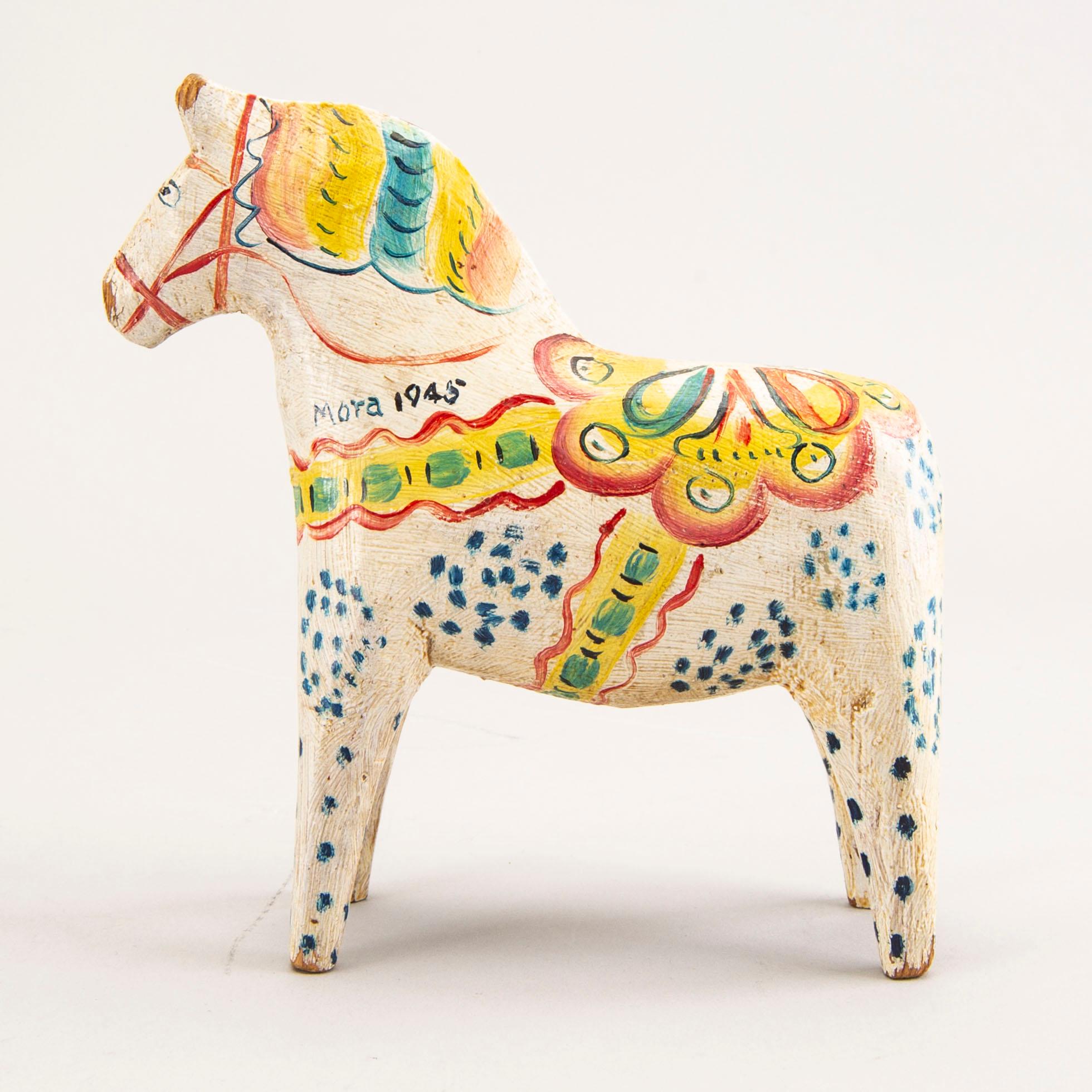 A Swedish painted and dated 1945 wooden horse.