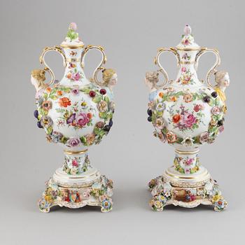 A pair of enamelled earthenware vases with covers, 20th century.