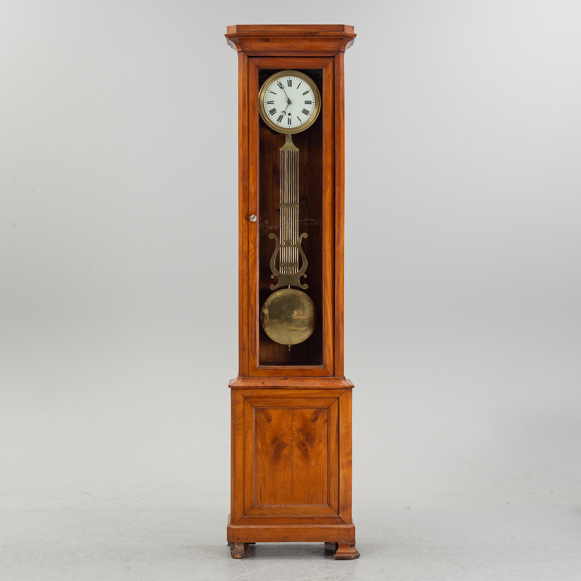 A walnut long case clock, from around the year 1900.