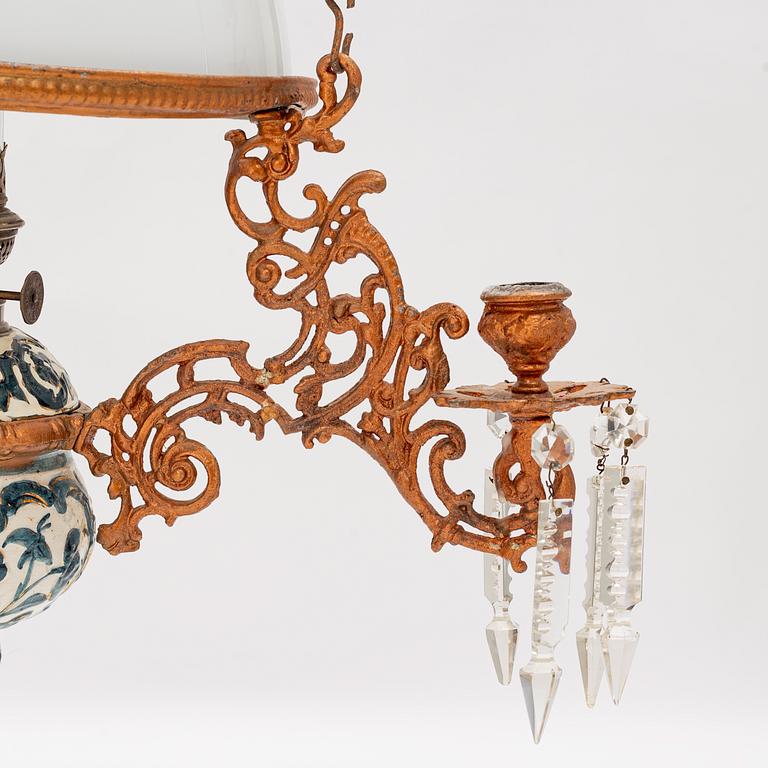 A ceiling carosene lamp, circa 1900.