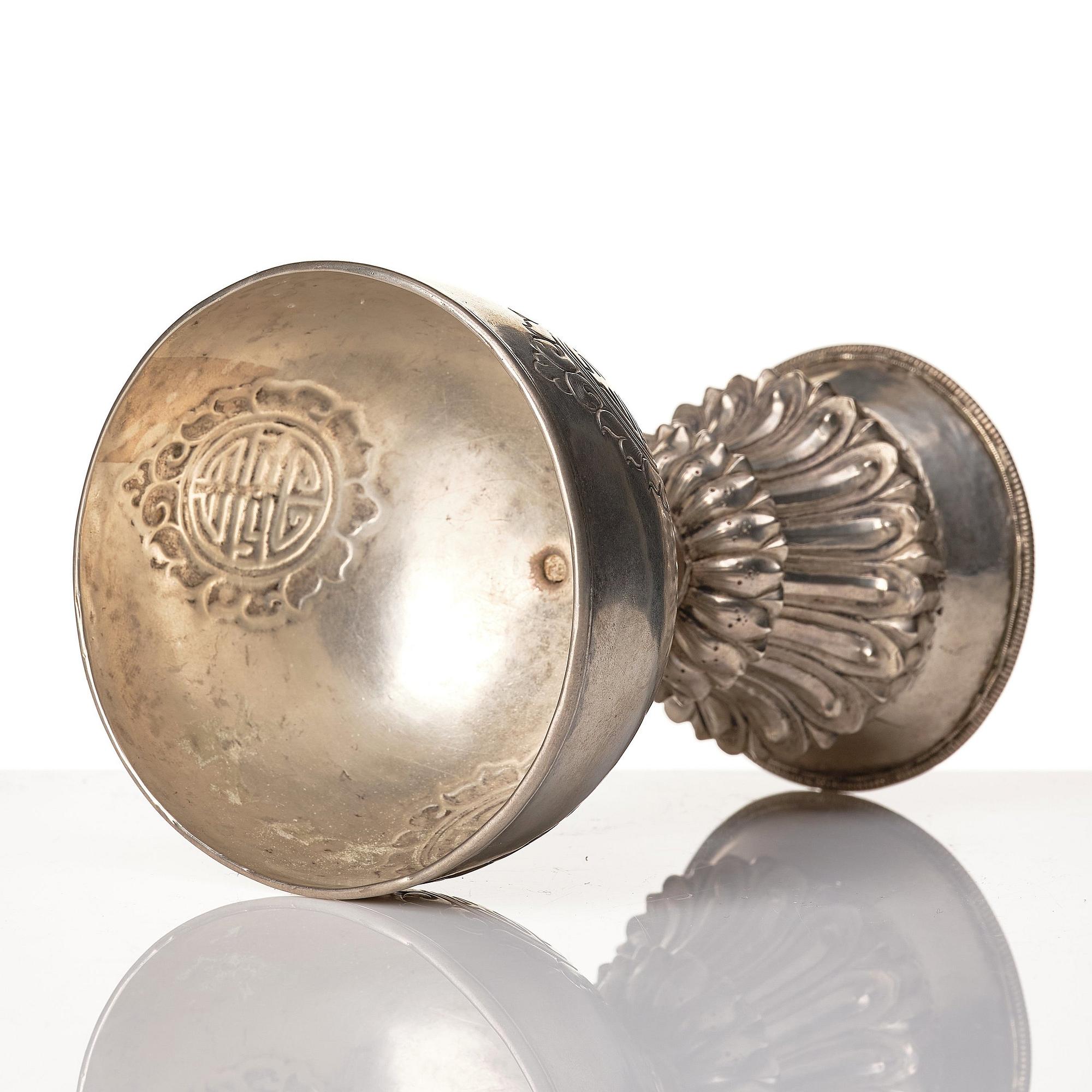 A Tibetan butter lamp, silvered copper, 20th century.