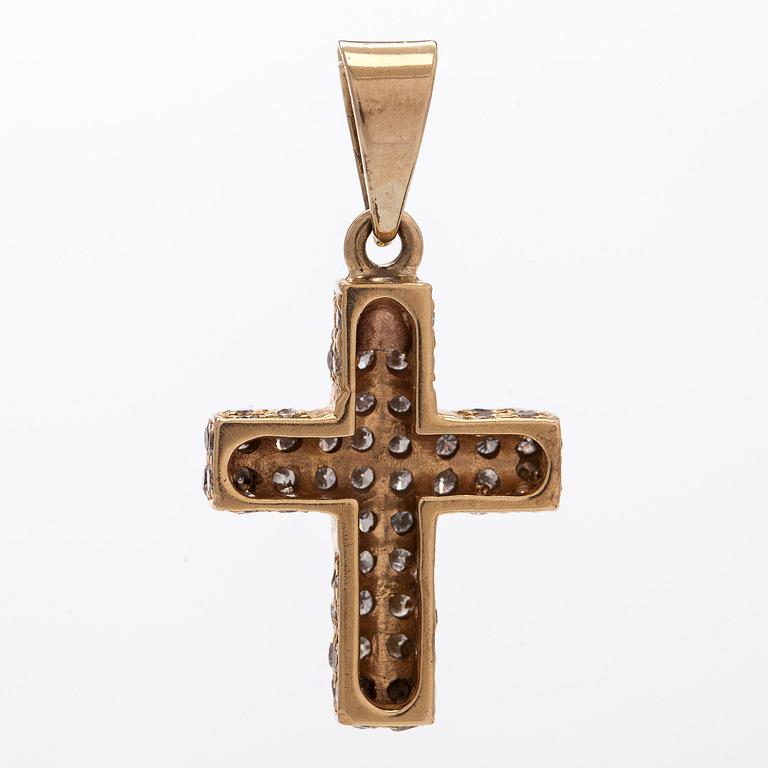 A 14K gold cross pendant with diamonds.