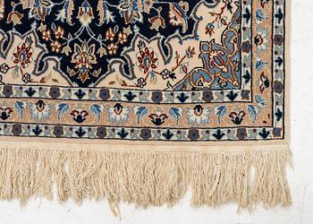 A Nain rug, part silk, c. 128 x 82 cm.