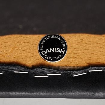 Niles Otto Møller, a rosewood veneered table with four chairs, JL Møller, Denmark, 1950's/60's.