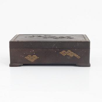 A japanese meji steel box with gold inlays and lid decorated with turtles and frogs. Signed.