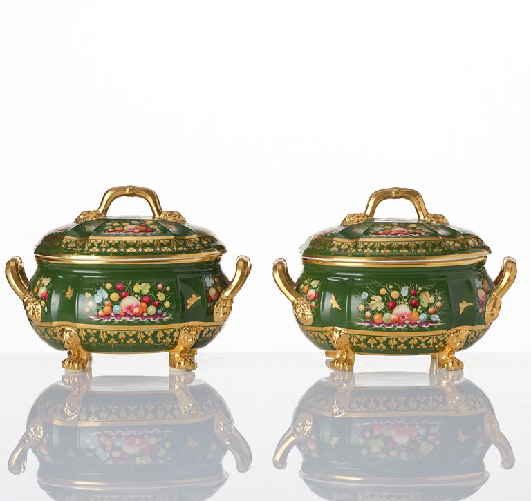 A pair of armorial butter tureens with covers and stands and two fruit dishes, Derby, England, circa 1830.